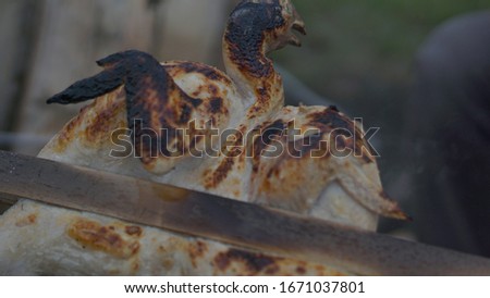Roast chicken uses charcoal and hot fire with the concept of camping. natural photo without editing