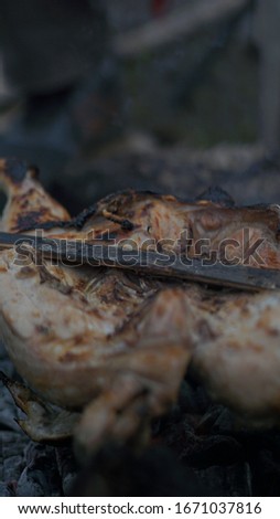 Roast chicken uses charcoal and hot fire with the concept of camping. natural photo without editing