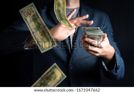 Business man throwing buch of dollar bills close up