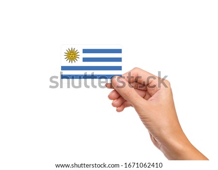 Beautiful hand holding Uruguay flag card with white background 