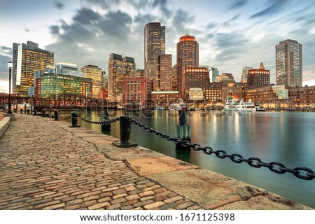 Downtown skyline city view of Boston Massachusetts USA looking over the riverfront harbor and marina boat dock from Fan Pier Park
