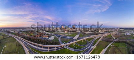 Aerial panorama picture of the Fort Worth skyline at sunrise with highway intersection in Texas