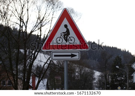 Traffic sign Cyclists with directional arrow