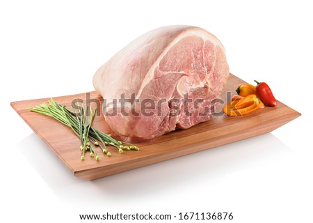Raw pernil (pernil asado, pernil al horno, roast pork butt). A slow-roasted marinated pork leg or pork shoulder, ready to be cooked. On a cutting board with peppers aside, isolated on white background Royalty-Free Stock Photo #1671136876