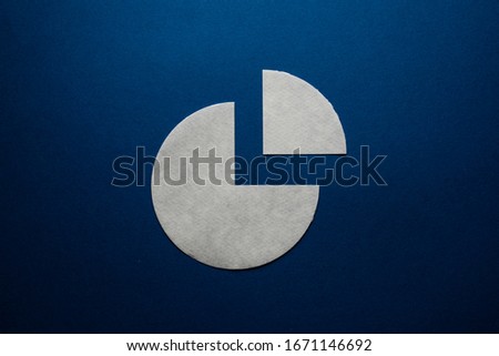 The gray paper circle is cut into one quarter with a piece on dark blue. Concept chart.