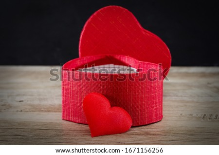 red heart on a wooden background. Close-up. Heart shaped box.