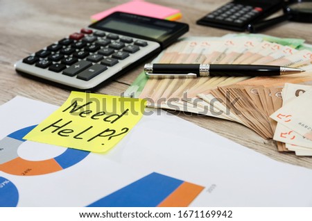 business concept. Money, calculator and business graph on the table. The inscription needs help.