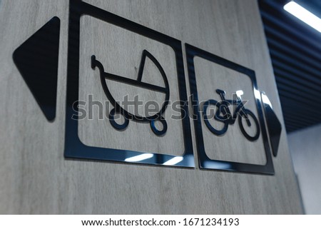 Signboard indicating facilities accessible for people in wheel chair or disability and for baby prams.