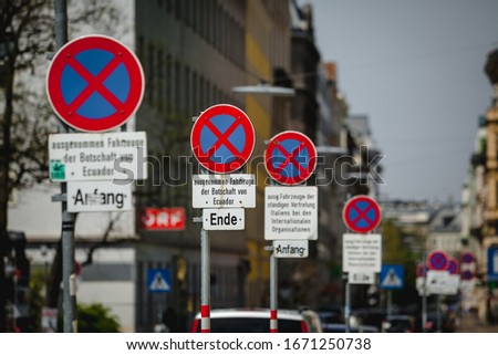 A lot of no stopping sign on single place at the street in the european city center indicating the areas where parking & stopping are forbidden