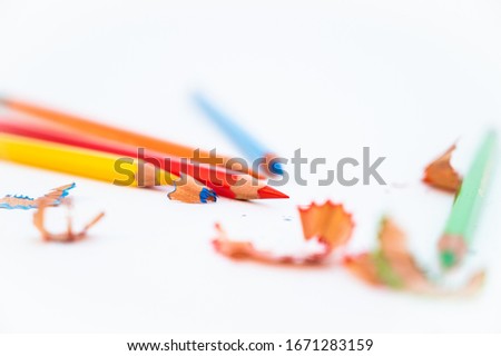 Colorful pencils with sharpening shavings, on white background. Color pencils isolated on white background. Copy space by color pencils.
