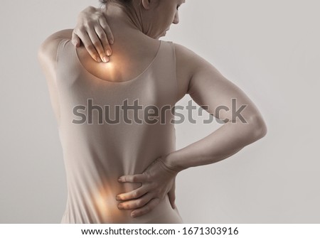 Woman suffering from back pain. Chiropractic, Physiotherapy concept Royalty-Free Stock Photo #1671303916