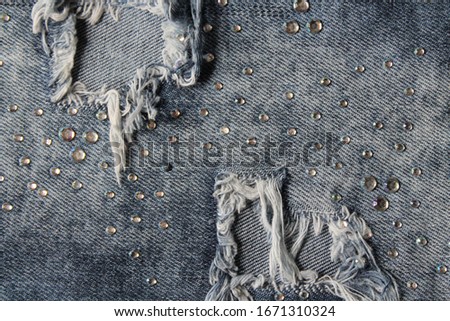 background texture blue ripped jeans with rhinestones
