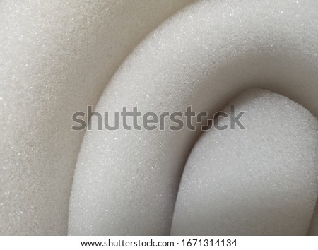 white sponge texture. elastic material is rolled up when packing. macro photography