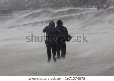 picture of a couple at the beach during a strong storm
