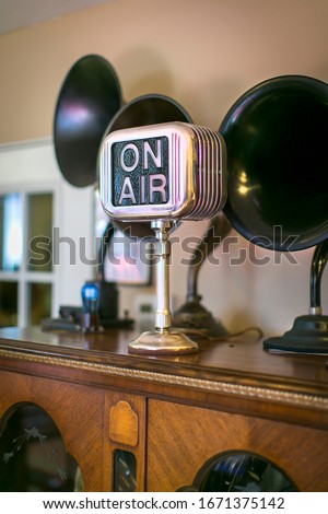 Vntage horn speakers and On Air sign on a piece of furniture