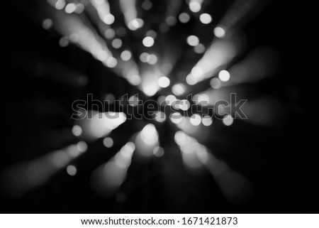  abstract background of blurred white bokeh is on  black background that is dispersing.