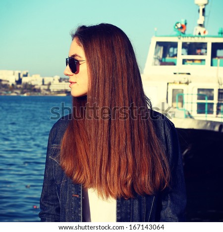 Model with long hair in sunglasses having fun. Lifestyle