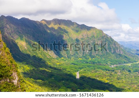 Incredible view from Nu‘uanu Pali Lookout in Honolulu on the island of Oahu, Hawaii, USA. Historical landmark and scenic spot with panoramic views. Royalty-Free Stock Photo #1671436126