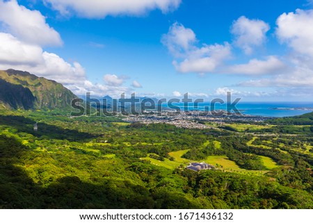 Incredible view from Nu‘uanu Pali Lookout in Honolulu on the island of Oahu, Hawaii, USA. Historical landmark and scenic spot with panoramic views. Diamond Head volcano at distance. Royalty-Free Stock Photo #1671436132