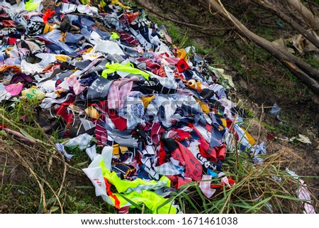 Trash that is a piece of cloth, old cloth is thrown away along the way. Waste that is difficult to degrade And cause pollution Royalty-Free Stock Photo #1671461038