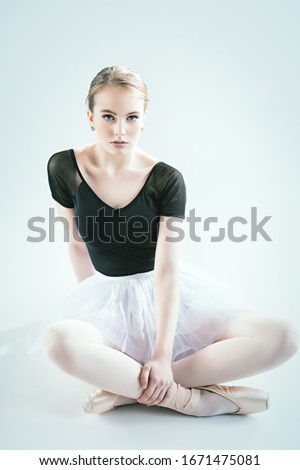 A full length portrait of an young ballerina posing in the studio over the white background. Talent, fashion for ballet dancers. 