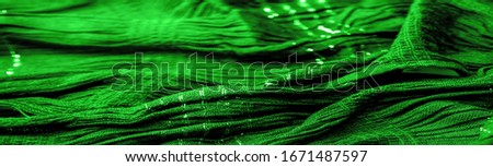 Background texture, ornament decor, emerald green centered corrugated fabric, fabric with parallel or diagonal folds of serrated folds; products from such a fabric.