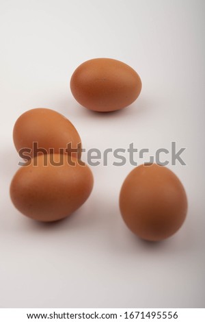 Chicken eggs scattered on a white background. Close up.