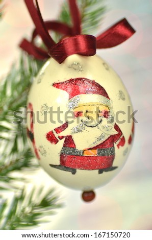 Christmas bauble  made by decoupage technique on bokeh background