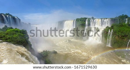 Part of The Iguazu Falls seen from the Brasilian National Park. South America, Latin America. Winter view of Iguazu Falls Devil's Throat cascade under heavy clouds lead sky. Royalty-Free Stock Photo #1671529630