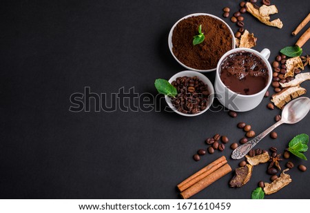 Mushroom Chaga Coffee Superfood Trend-dry and fresh mushrooms and coffee beans on dark background with mint. Coffee break