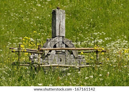 an old wooden Celtic cross on a green meadow
