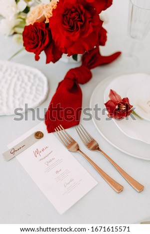 Graphic arts decor for a wedding ceremony. Postcards with elements of Marsala. Wedding invitations with red roses. 
