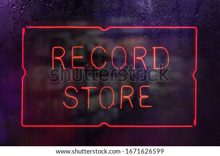 Vintage Neon Record Store Sign in Rainy Window
