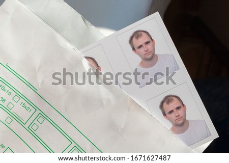 Photos on the passport of a young man in an envelope.