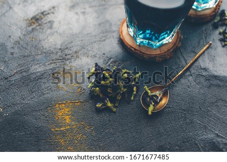 Butterfly pea flower blue tea. Detox drinking on dark table. Healthy herbal drink. Blue herbal tea anchan with lime