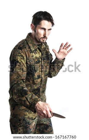 Male self defense instructor with camouflage do a self defense exercise with knife, isolated on white background