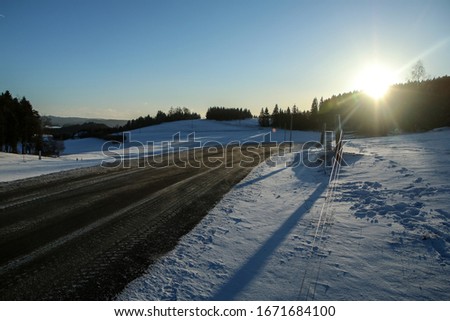 The picture illustrates the winter conditions on roads, when the ice, snow and frost is on the tarmac.