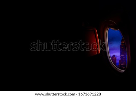 Black background with copy space look of window seat frame of airplane flight see view of clouds sky, wing travel during coronavirus risk crisis fall demand of flight cancel  Royalty-Free Stock Photo #1671691228