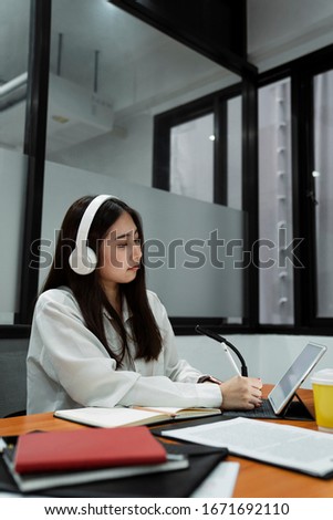 Working woman thinking something while she use her tablet to searching the information.