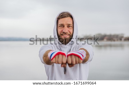 Portrait of a smiling boxer with bandages on his hands