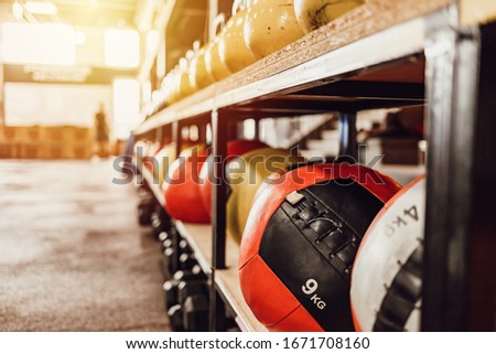 Kettlebell and medicine ball in the gym. Equipment for functional training. Shot of the interior of a health club. Kettlebells with various colors. Fitness equipment in fitness