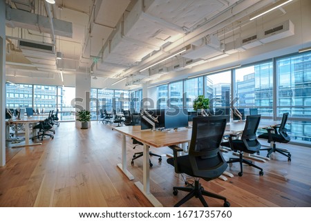 Interior of modern empty office building.Open ceiling design. Royalty-Free Stock Photo #1671735760