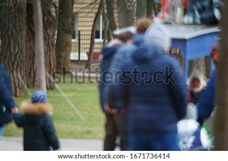 Blurred background. People walk in the recreation Park.