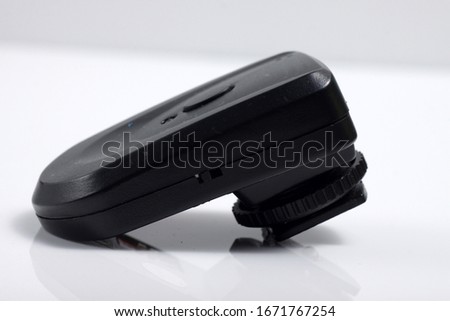 Close up shot of black camera flash trigger isolated on white background