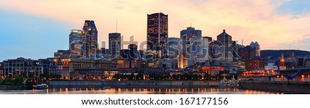 Montreal over river panorama at dusk with city lights and urban buildings