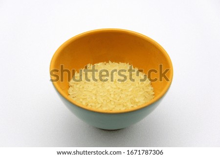 Ceramic bowlwith rice on a white background, top view. The concept of healthy nutrition, diets, vegetarian products. Stock photo with empty space for text and design.