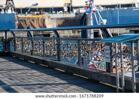 A picture of many love padlocks attaching to the fence.  Vancouver BC Canada
