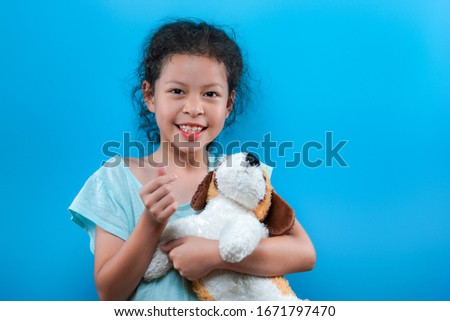 Cute little asian girl portrait with blue background.