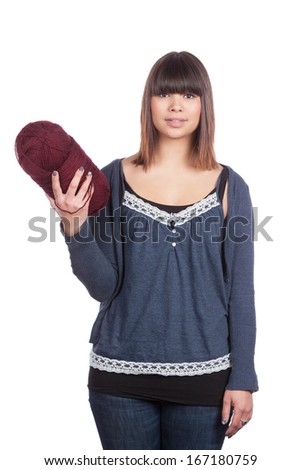 Cut out image of a young woman who holds a ball of wool