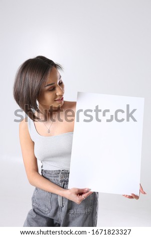Cute young woman posing in studio